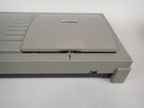 a nintendo game console sitting on a white surface
