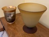 two bowls sitting on a table next to each other