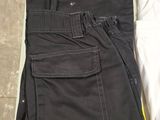 two pairs of black pants sitting on top of a white box