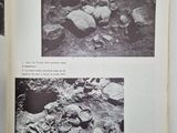 an open book with black and white photos of a man laying on a rock