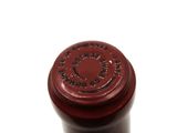a close up of a bottle of wine on a white surface