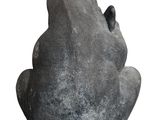 a stone statue of a frog sitting on top of a rock