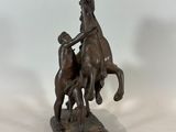 bronze statue of a man on a horse with a woman on a horse