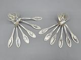 pair of silver plated spoons with leaves on them