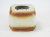 a brown and white vase on a white surface