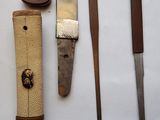 several different types of knives on a white surface