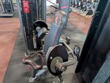 a gym with a lot of machines in the room
