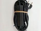 a close up of a charger on a white surface with a cord