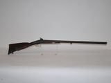 a rifle on a table with a white background