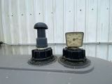 two gauges on the top of a tank