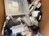 a cardboard box full of assorted items in it
