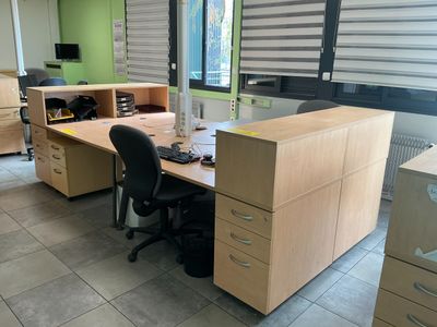 an image of an office with two desks and a chair