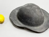 a black hat and a lemon on a table