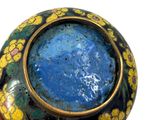 a blue and yellow vase sitting on top of a table