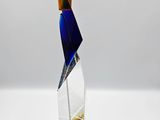 a clear glass sculpture with a geometric design on top of it