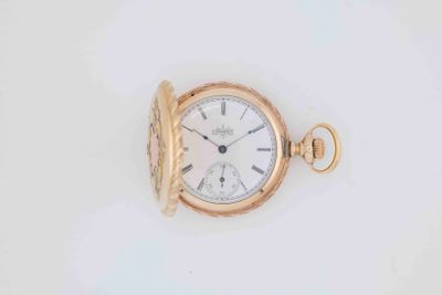 an image of a gold pocket watch on a white surface