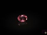 a pink diamond on a black surface