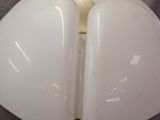 a white lamp that is on a stand on a table