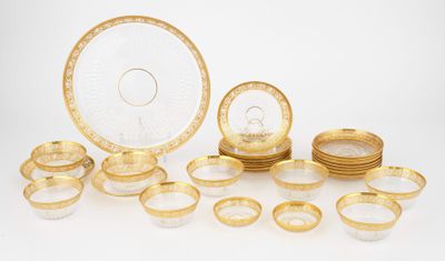 an assortment of gold and white dishes and plates on a white surface
