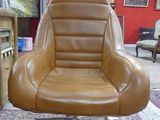 a brown office chair that is sitting on a rug