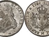 a silver coin with an image of a man in a crown on it