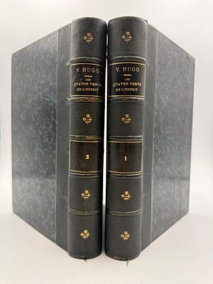 the two books are lined up in a row on a white surface