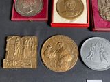 several different types of silver and gold medals in a red case