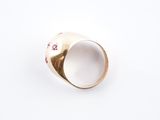 a close up of a gold ring with pink flowers on it