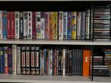 a book shelf with many dvds on it