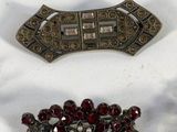 several pieces of jewelry are displayed on a white surface