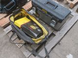 two tool cases sitting on a pallet next to a tool box