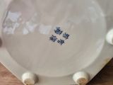 a close up of a white plate on a wooden table