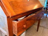 a wooden desk with a drawer on top of it