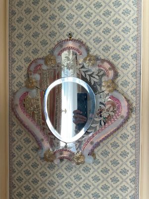 a mirror hanging on the wall above a sink