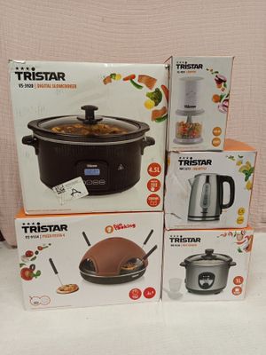 three boxes of different types of kitchen appliances sitting on a table