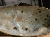 a bowl with holes in it sitting on a table