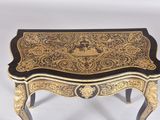 an image of a small table with a black and gold decoration