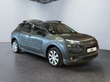 the grey citrole is parked in a large room