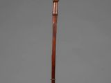 an old wooden stick with a wooden handle on a gray background