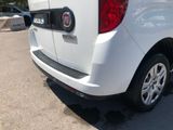 a small white van parked in a parking lot