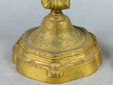 a gold statue of a woman on a pedestal