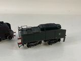 two toy trains that are sitting on a white surface