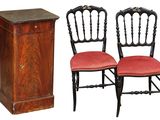 two chairs that are sitting next to a cabinet