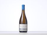 a bottle of white wine sitting on top of a table