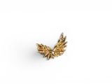 a close up of a gold leaf brooch on a white background