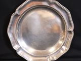 a silver plate that is sitting on a black table