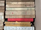 a box full of old books sitting on top of each other