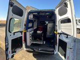 a white van with its doors open on the side of the road
