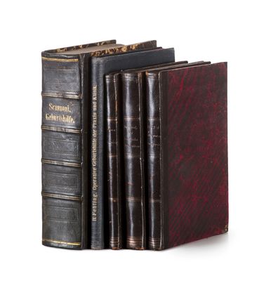 three books are stacked on top of each other on a white surface