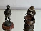 two figurines that are sitting on top of a table